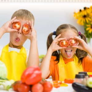 Kids having fun cooking healthy food together